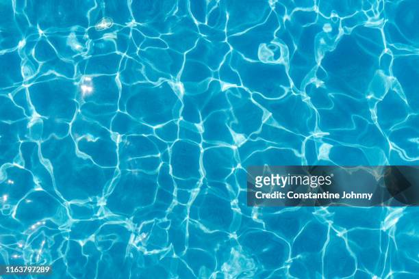 swimming pool surface with light reflection and water ripple patterns - プール ストックフォトと画像