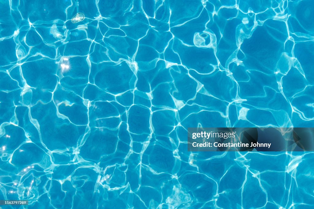 Swimming Pool Surface With Light Reflection and Water Ripple Patterns