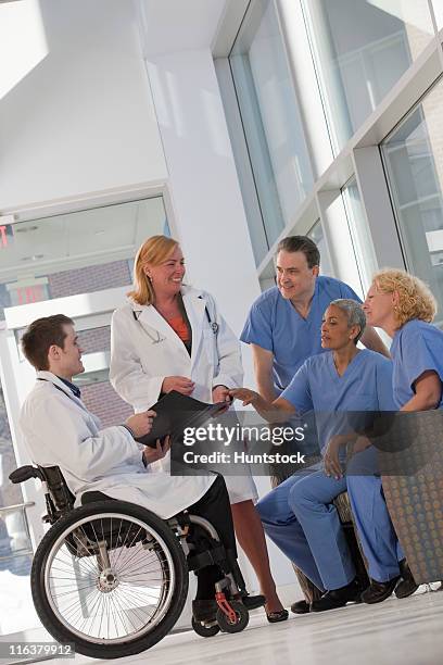 doctor with spinal cord injury in a wheelchair meeting with hospital staff - massachusetts conference for women stock-fotos und bilder