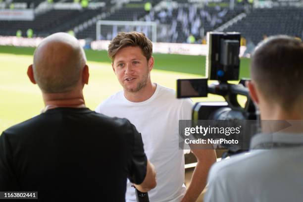 Rams supporter and One Direction singer, Niall Horan being interviewed ahed of the Sky Bet Championship match between Derby County and West Bromwich...