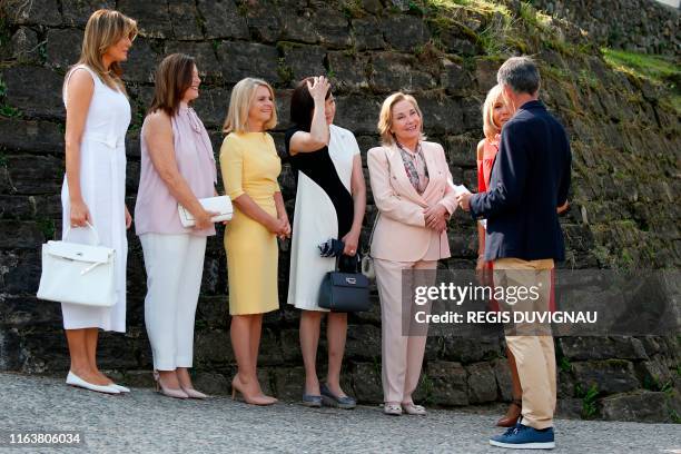Wife of French President Brigitte Macron and Mayor of Espelette Jean-Marie Iputcha welcome the spouses of the G7 World leaders US First Lady Melania...