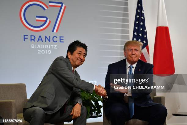 President Donald Trump shakes hands with Japan's Prime Minister Shinzo Abe during a bilateral meeting at the Bellevue in Biarritz, south-west France...