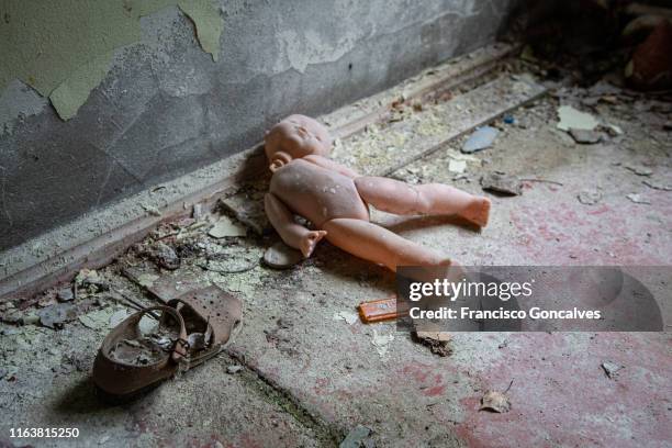 broken doll and old shoe in an abandoned building of chernobyl exclusion zone - broken doll stock pictures, royalty-free photos & images