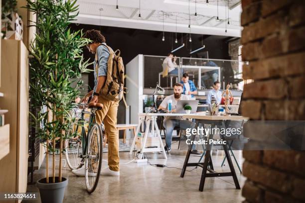 arriving to work by bike - cool attitude stock pictures, royalty-free photos & images