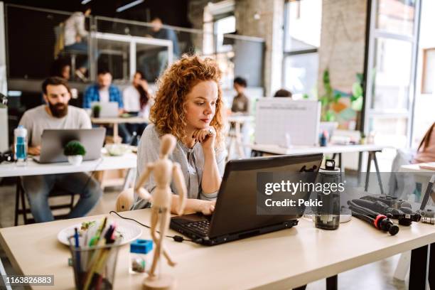 creative woman working at office - reusable water bottle office stock pictures, royalty-free photos & images