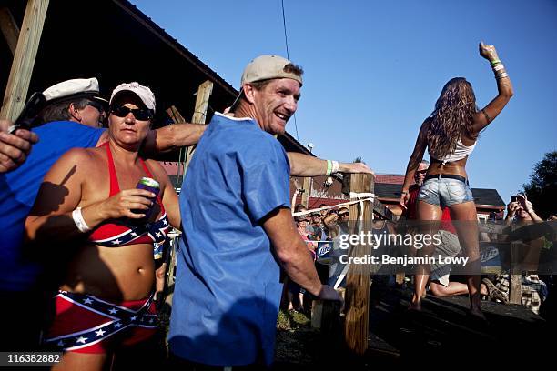 Raucous crowd cheers during a wet t-shirt contest following the completion of the Redneck Fishing Contest on August 7 2010 in Bath, IL. The contest,...