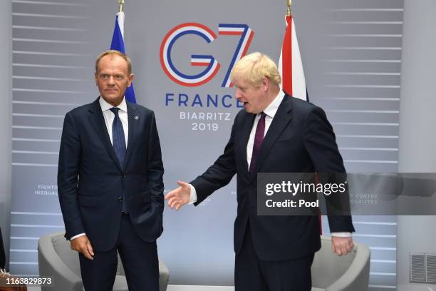 Britain's Prime Minister, Boris Johnson meets with President of the European Council, Donald Tusk at the G7 summit on August 25, 2019 in Biarritz,...