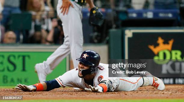 Yuli Gurriel of the Houston Astros scores in the second inning on his inside-the-park home run against the Oakland Athletics at Minute Maid Park on...