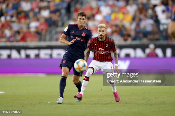 Benjamin Pavard of FC Bayern Muenchen battles for the ball with Samu Castillejo of AC Milan during the 2019 International Champions Cup match between...