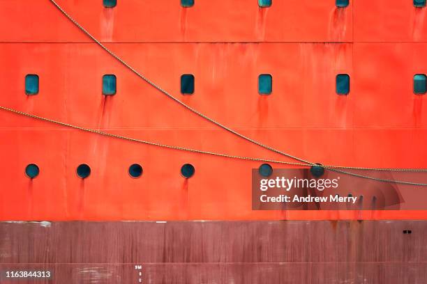 bright safety orange icebreaker ship hull - ship hull stock pictures, royalty-free photos & images