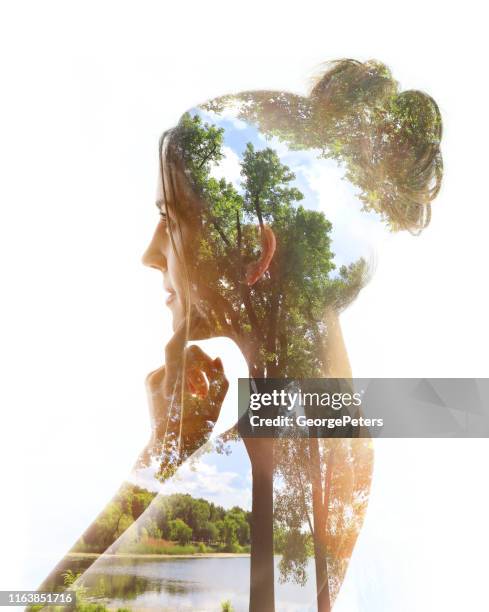 multiple exposure of a young woman, lake and forest - multiple exposure stock pictures, royalty-free photos & images