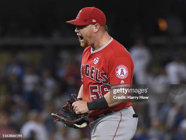 Kole Calhoun of the Los Angeles Angels celebrates after throwing out Cody Bellinger of the Los Angeles Dodgers at home to end the game for a 5-4...