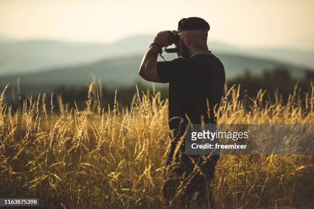 soldier is supervising the terain - spy hunter stock pictures, royalty-free photos & images