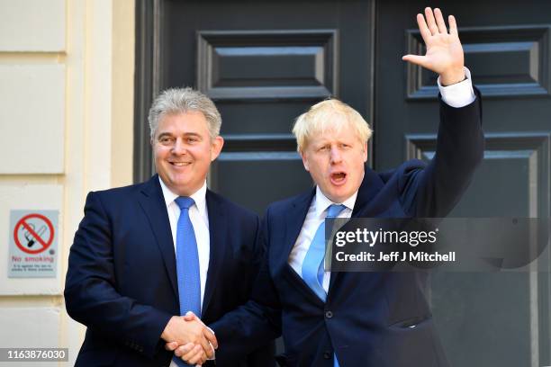 Newly elected leader of the Conservative party Boris Johnson shakes hands with Chairman of Conservative Party Brandon Lewis as he arrives at...
