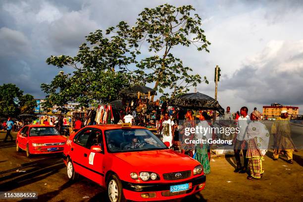 Taxis and pedestrians in Abidjan, Ivory Coast.