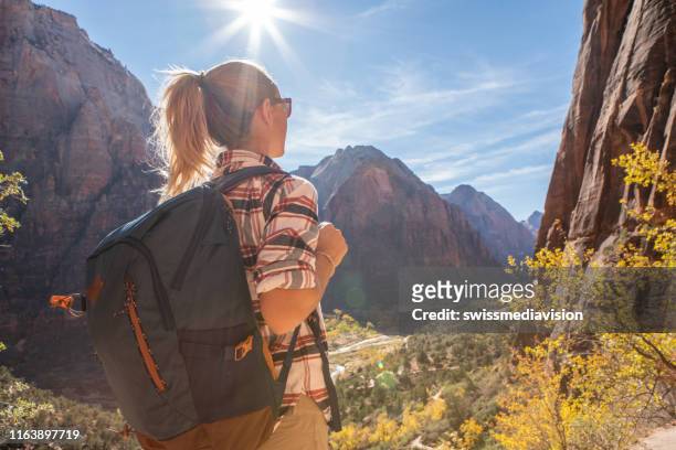 woman hiking in usa taking a rest on top of valley - zion national park stock pictures, royalty-free photos & images