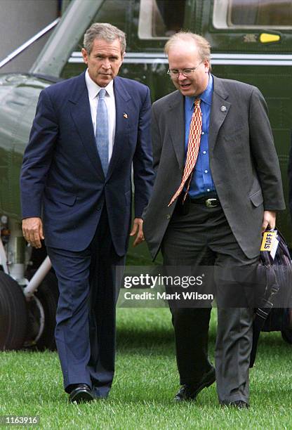 President George W. Bush walks with his chief political adviser Karl Rove after returning to the White House September 27, 2001 in Washington, DC.