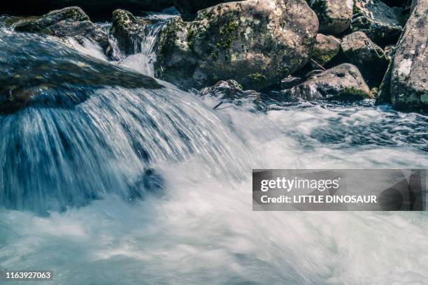 mountain stream. at akame 48 waterfalls. long exposure. close-up - spring flowing water stock-fotos und bilder