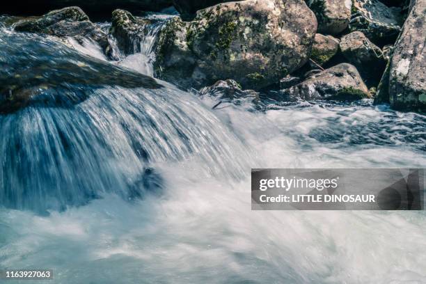 mountain stream. at akame 48 waterfalls. long exposure. close-up - sources stockfoto's en -beelden