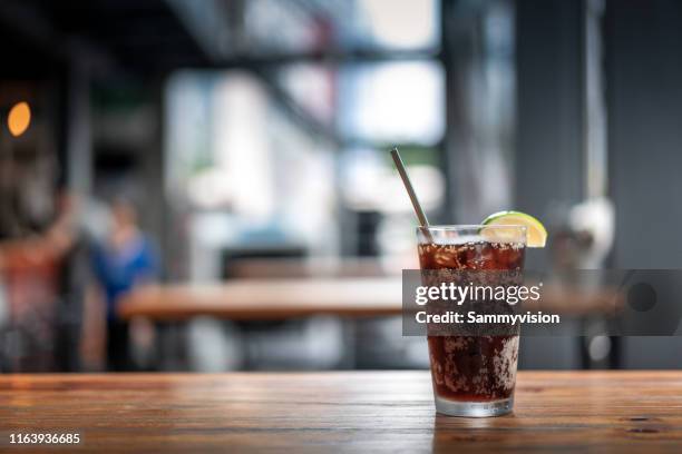 glasses of cola on the table - koude dranken stockfoto's en -beelden