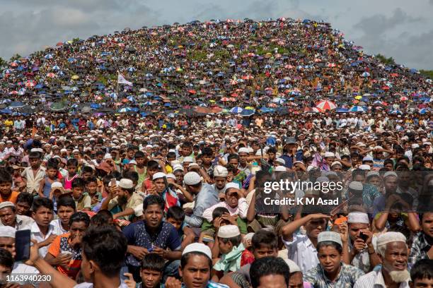 Rohingya refugees gather in the open field at kutupalong refugee camp to commemorate the second anniversary of the 2017 crisis when they were forced...