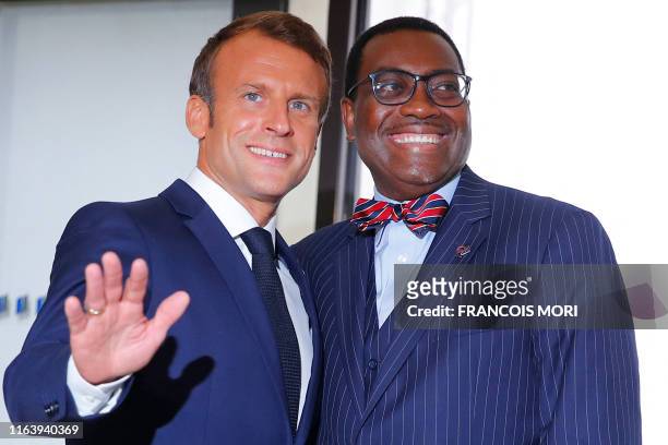 French President Emmanuel Macron welcomes African Development Bank president Akinwumi Adesina, upon his arrival in Biarritz, south-west France on...