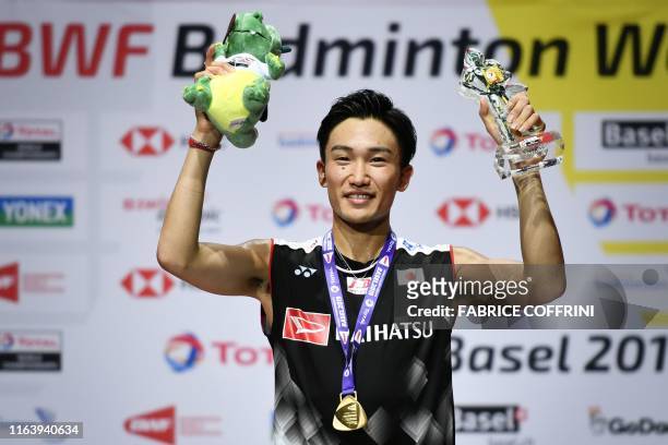First-placed Japan's Kento Momota poses with his gold medal during the podium cermony after his victory over Denmark's Anders Antonsen during the...