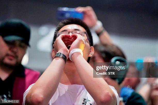 Fan cheers as team OG celbrates their win at the Dota 2 eSports Best of 5 final match during the International Dota 2 Championships in Shanghai on...