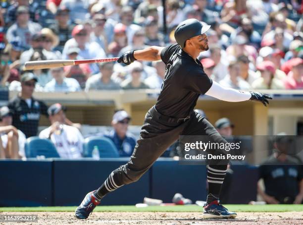 Martinez of the Boston Red Sox hits a solo home run during the fourth inning of a baseball game against the San Diego Padres at Petco Park August 25,...