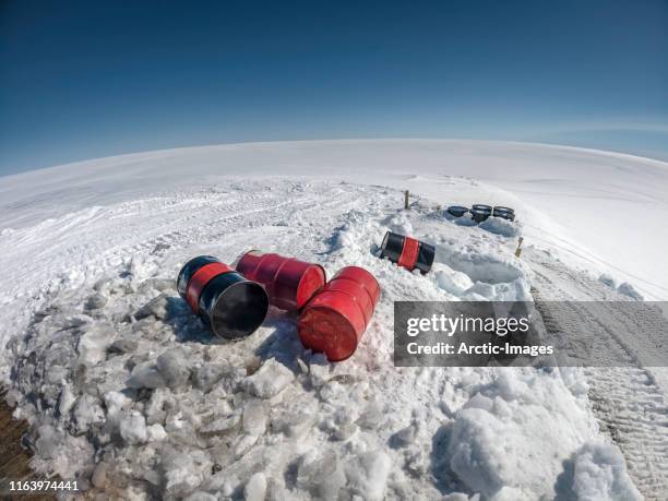 oil barrels, vatnajokull ice cap, iceland - arctic oil stock-fotos und bilder