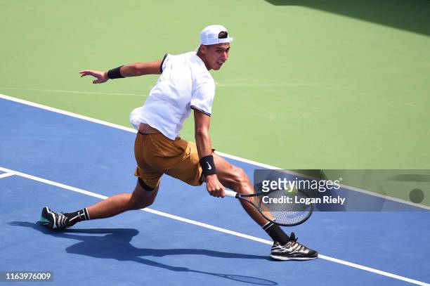 Alexei Popyrin of Australia returns a backhand to Pierre-Hugues Herbert of France during the BB&T Atlanta Open at Atlantic Station on July 24, 2019...