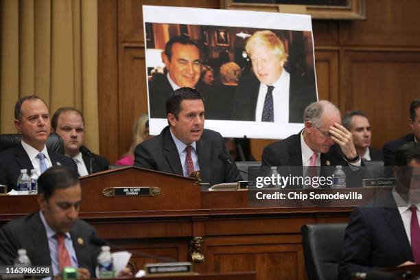 With a photograph of British Prime Minister Boris Johnson and Joseph Mifsud in the background, ranking member Rep. Devin Nunes questions former...