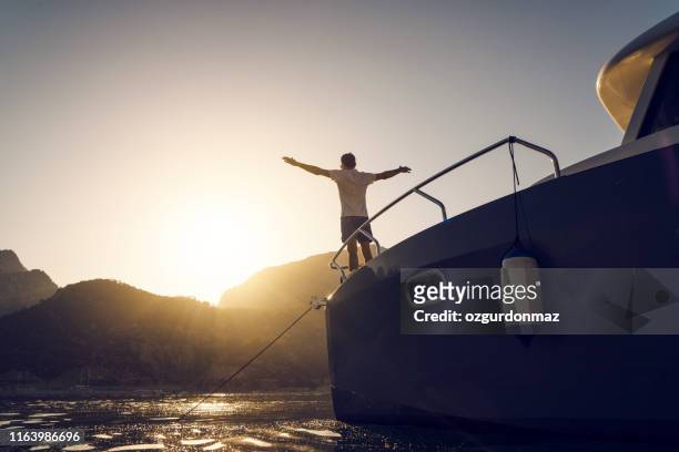 man in yacht enjoying the sunset, antalya, turkey - yachting lifestyle stock pictures, royalty-free photos & images