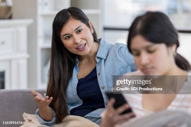 teen ignores mom to surf the net - aunt stock pictures, royalty-free photos & images