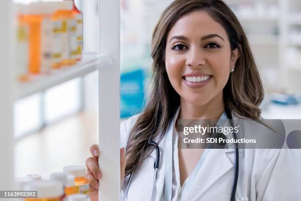 portrait of female pharmacist - long term care stock pictures, royalty-free photos & images