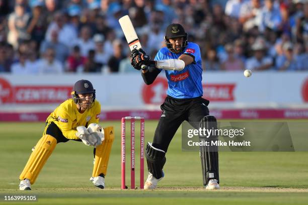 David Wiese of Sussex hits out as Lewis McManus of Hampshire looks on during the Vitality Blast match between Sussex Sharks and Hampshire at The 1st...