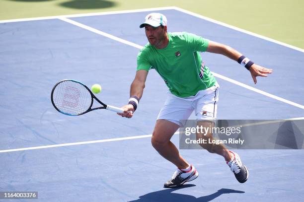 Jonathan Erlich of Israel returns a forehand to Miomir Kecmanovic of Serbia and Robert Lindstedt of Sweden during the BB&T Atlanta Open at Atlantic...