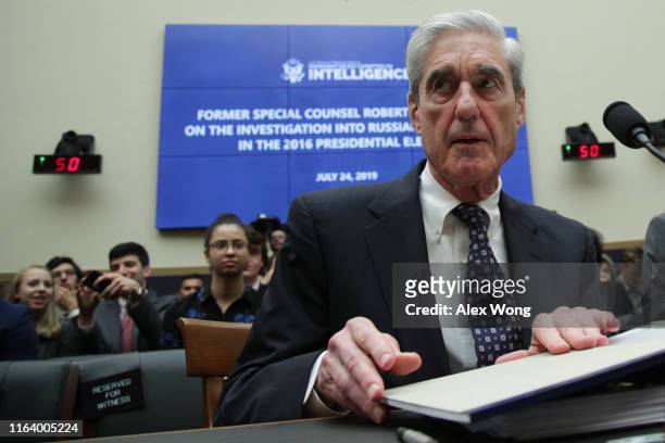 Former Special Counsel Robert Mueller waits to testify before the House Intelligence Committee about his report on Russian interference in the 2016...
