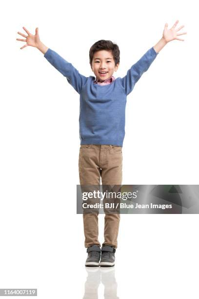 happy little chinese boy - 腕を上げる ストックフォトと画像