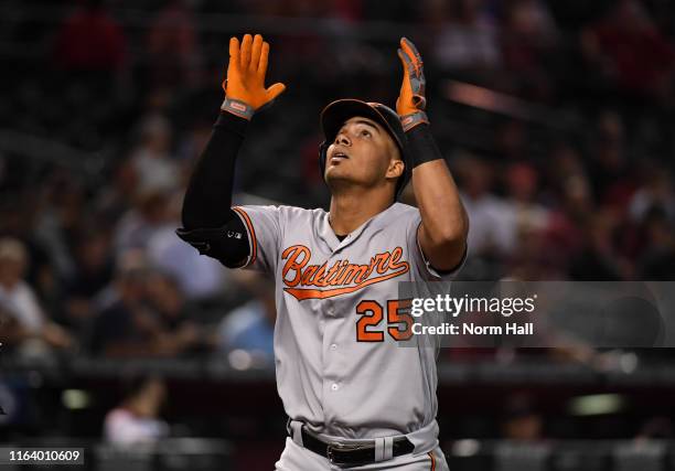 Anthony Santander of the Baltimore Orioles gestures to the sky after hitting a solo home run off of Taylor Clarke of the Arizona Diamondbacks during...