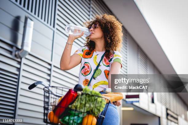 hydration during the summer. a young woman drinks water - cat drinking water stock pictures, royalty-free photos & images