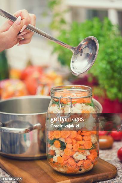 preserving cauliflower, carrots and garlic in a jars - canning stock pictures, royalty-free photos & images