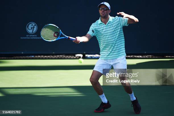 Mike Bryan returns a forehand to Christopher Eubanks and Donald Young during the BB&T Atlanta Open at Atlantic Station on July 24, 2019 in Atlanta,...