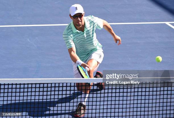 Mike Bryan returns a forehand to Christopher Eubanks and Donald Young during the BB&T Atlanta Open at Atlantic Station on July 24, 2019 in Atlanta,...