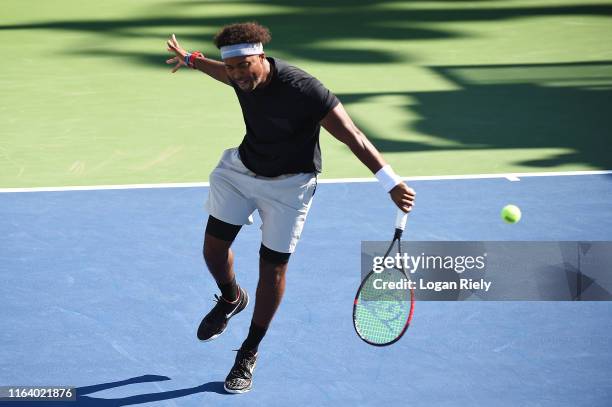 Donald Young returns a backhand to Mike Bryan and Bob Bryan during the BB&T Atlanta Open at Atlantic Station on July 24, 2019 in Atlanta, Georgia.