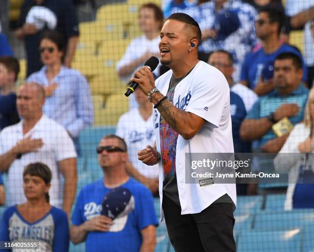 Singer Andy Vargas performs the National Anthem before the game between the Los Angeles Dodgers and the Miami Marlins at Dodger Stadium on July 20,...