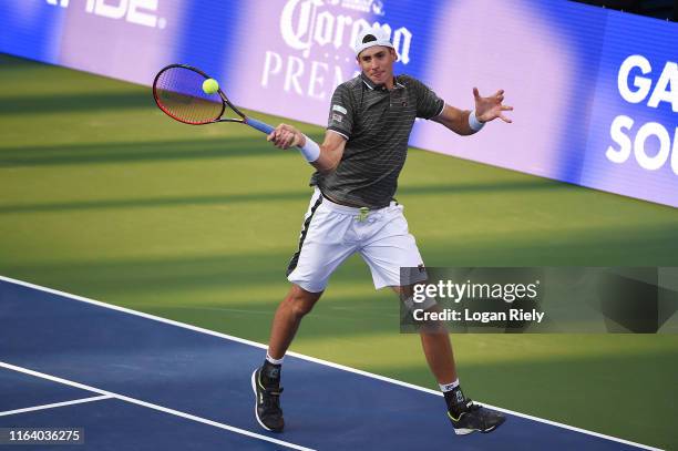 John Isner returns a forehand to Reilly Opelka during the BB&T Atlanta Open at Atlantic Station on July 24, 2019 in Atlanta, Georgia.