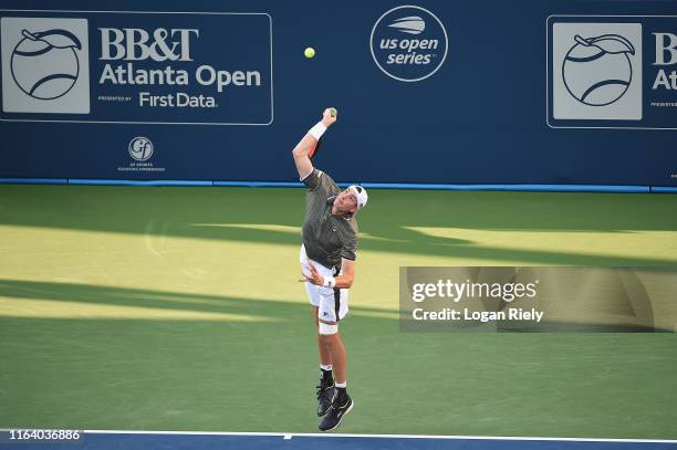 John Isner serves to Reilly Opelka during the BB&T Atlanta Open at Atlantic Station on July 24, 2019 in Atlanta, Georgia.