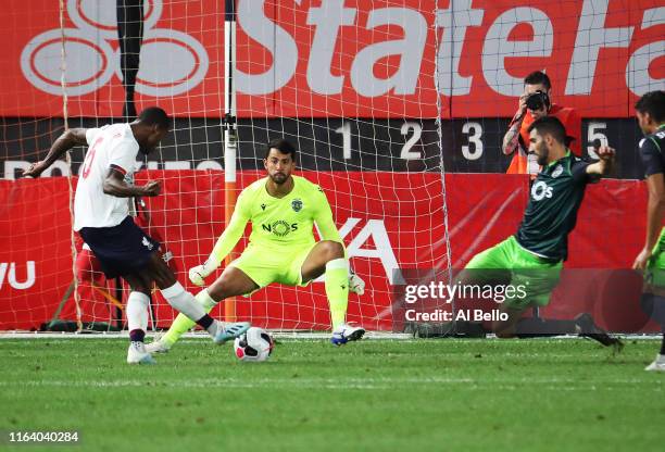 Georginio Wijnaldum of Liverpool scores against Renan Ribeiro of Sporting CP during their preseason friendly match at Yankee Stadium on July 24, 2019...