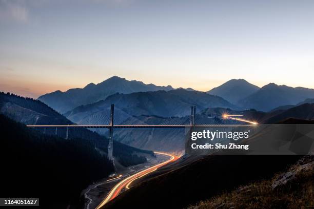 the carlight trail in the road and bridge - road top view stock pictures, royalty-free photos & images